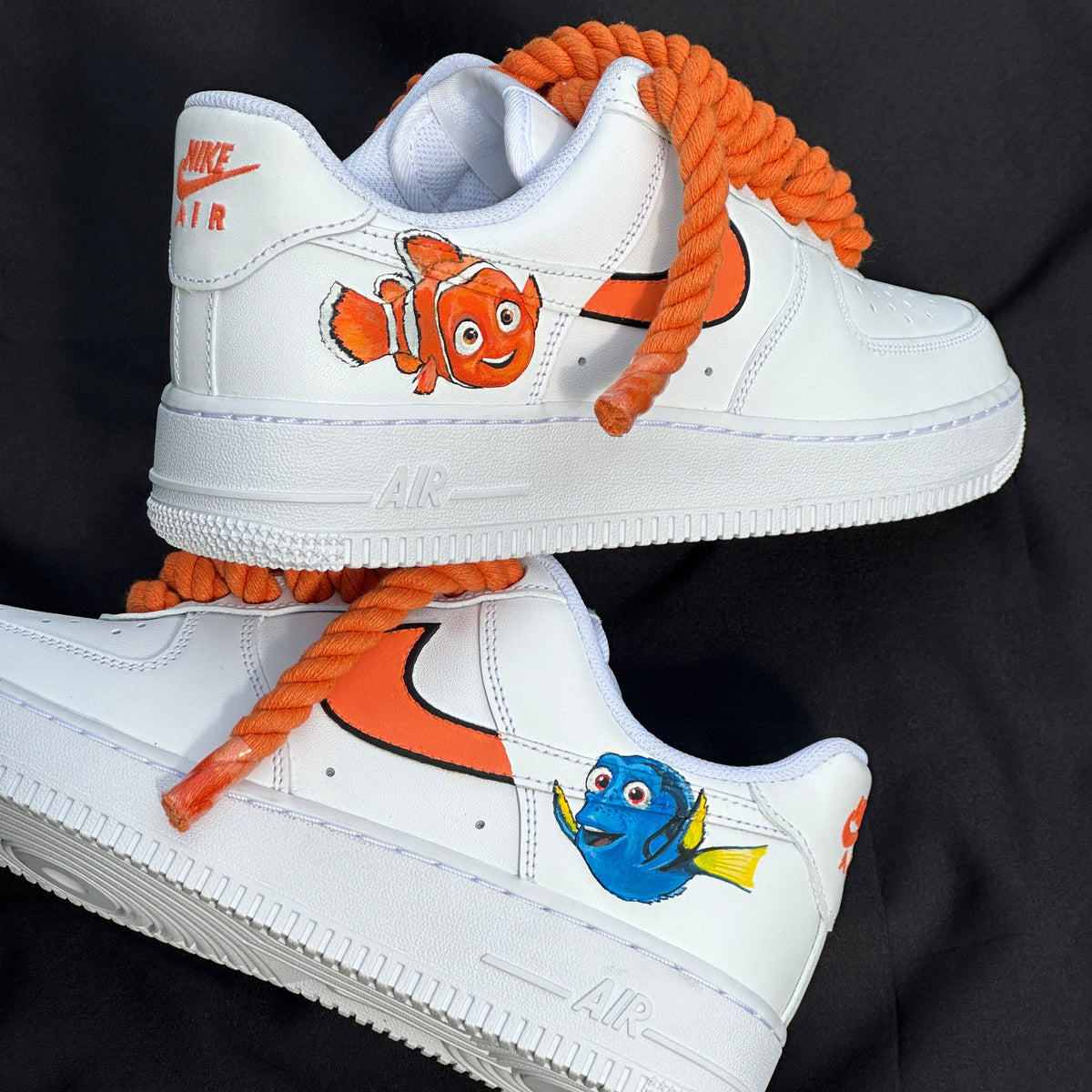 White sneakers with cartoon character designs on a black background