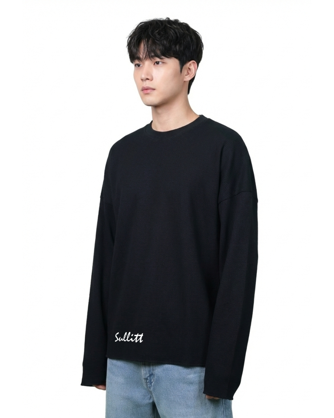 Person wearing a black sweatshirt with white text on a white background