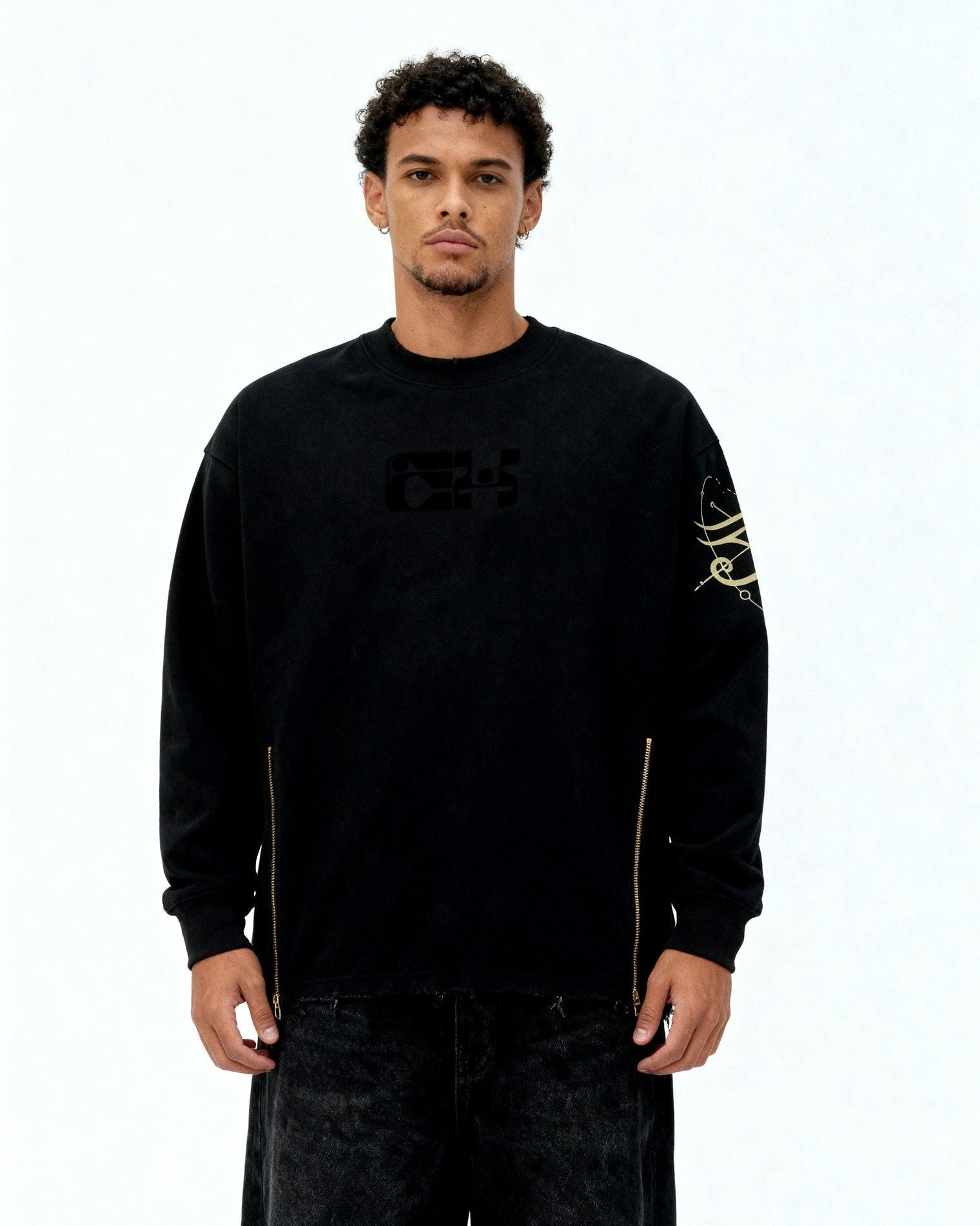 Man wearing a black sweatshirt with logos on a white background